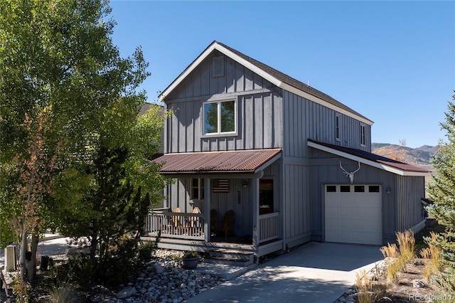 230 Buckhorn Cir, Granby, CO 80446 - view of front of house featuring a porch, driveway, board and batten siding, and a garage