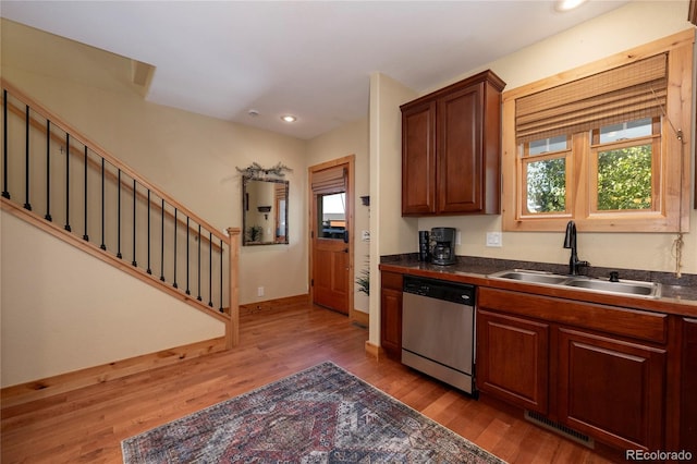 230 Buckhorn Cir, Granby, CO 80446 - kitchen featuring stainless steel dishwasher, a sink, dark countertops, light wood finished floors, and recessed lighting