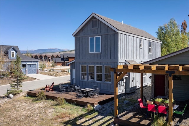 230 Buckhorn Cir, Granby, CO 80446 - back of house with board and batten siding and a deck with mountain view
