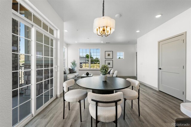 18633 Stroh Rd Unit 2-206, Parker, CO 80134 - dining space with an inviting chandelier, recessed lighting, baseboards, and wood finished floors