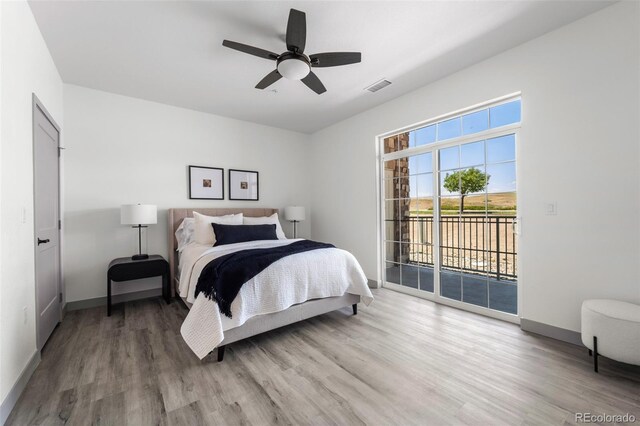 18633 Stroh Rd Unit 2-206, Parker, CO 80134 - bedroom featuring wood finished floors, baseboards, access to exterior, and visible vents