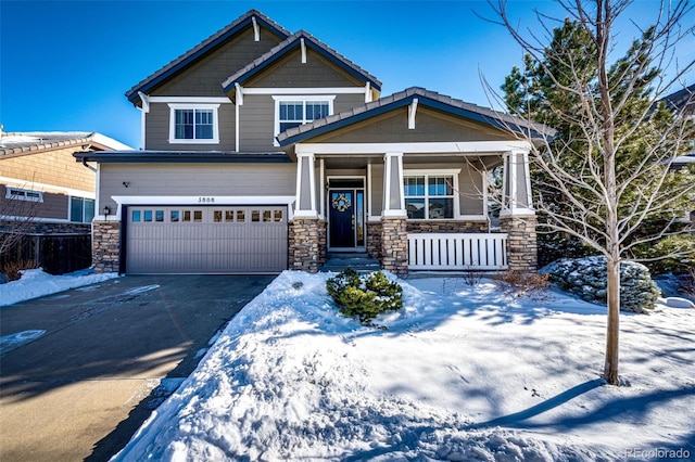 craftsman-style house featuring a garage and covered porch