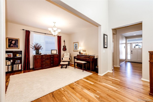 sitting room with a chandelier and light hardwood / wood-style flooring