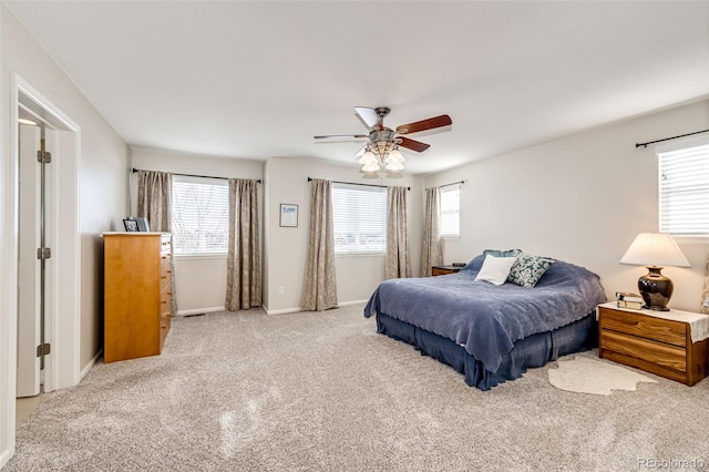 bedroom featuring ceiling fan and light carpet