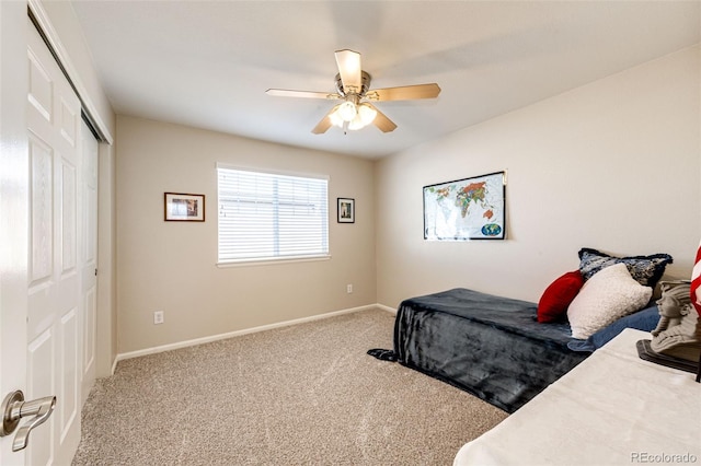 bedroom with ceiling fan, a closet, and carpet flooring