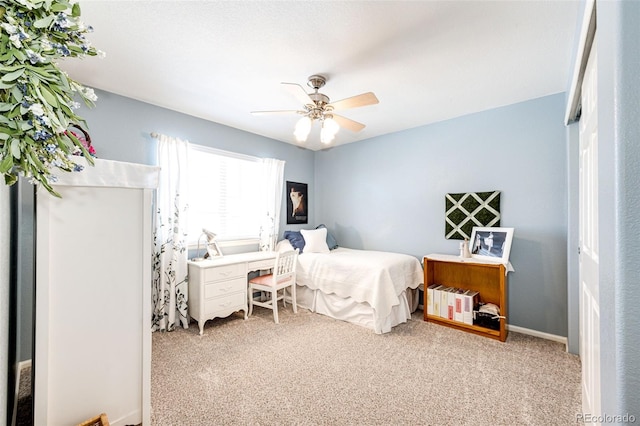 carpeted bedroom with ceiling fan and a closet