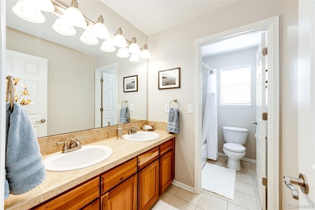 bathroom featuring toilet, tile patterned floors, and vanity