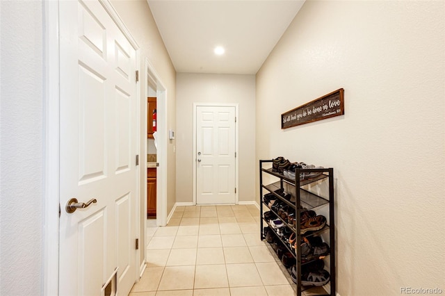 hallway featuring light tile patterned floors