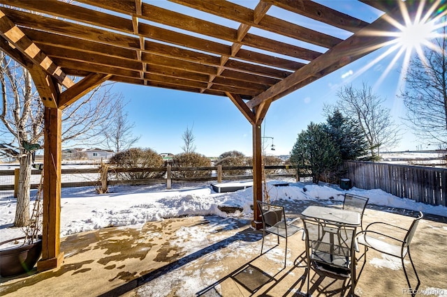 snow covered patio with a pergola