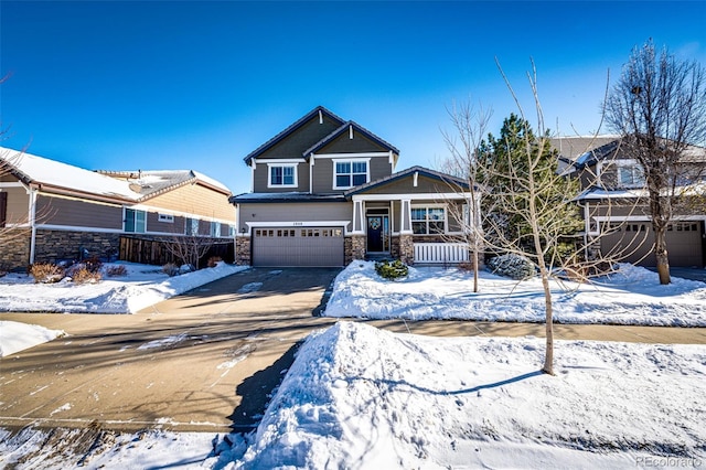 craftsman-style home featuring covered porch and a garage