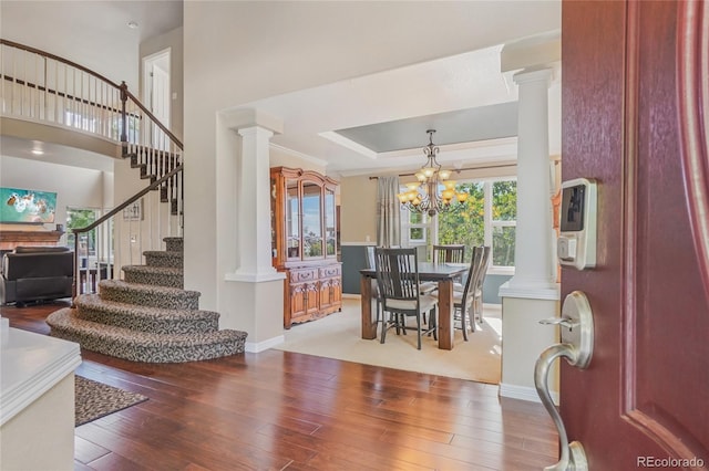 16071 Crestrock Cir, Parker, CO 80134 - entrance foyer featuring decorative columns, stairs, hardwood / wood-style flooring, and a chandelier