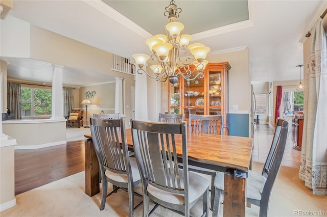 16071 Crestrock Cir, Parker, CO 80134 - dining area featuring healthy amount of natural light, a chandelier, wood finished floors, a tray ceiling, and ornamental molding