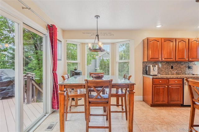 16071 Crestrock Cir, Parker, CO 80134 - kitchen with plenty of natural light, backsplash, pendant lighting, and brown cabinets