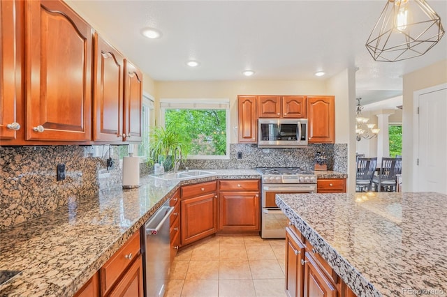 16071 Crestrock Cir, Parker, CO 80134 - kitchen featuring stainless steel appliances, decorative backsplash, light tile patterned floors, pendant lighting, and brown cabinetry