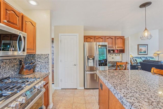 16071 Crestrock Cir, Parker, CO 80134 - kitchen featuring stainless steel appliances, tasteful backsplash, hanging light fixtures, and light tile patterned floors