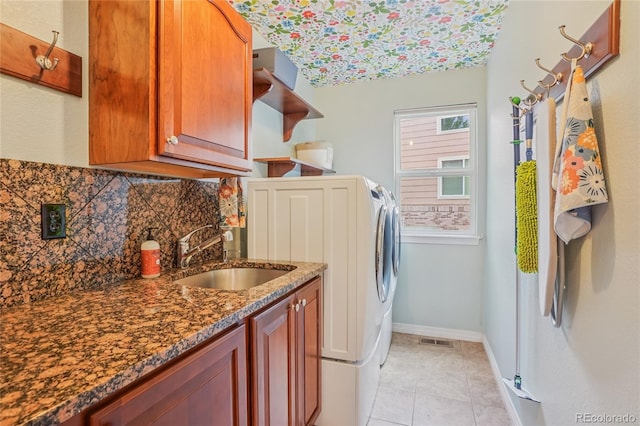 16071 Crestrock Cir, Parker, CO 80134 - laundry area with cabinet space, light tile patterned floors, and separate washer and dryer