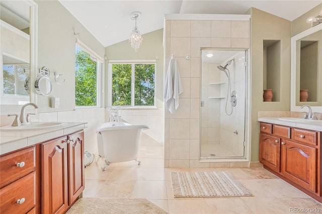 16071 Crestrock Cir, Parker, CO 80134 - full bath featuring a shower stall, two vanities, a soaking tub, lofted ceiling, and tile patterned floors