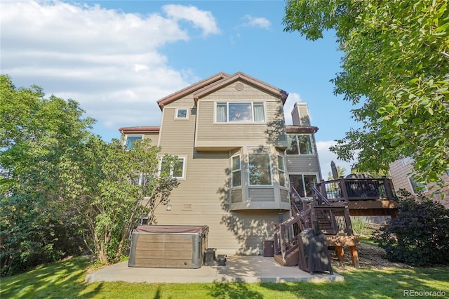 16071 Crestrock Cir, Parker, CO 80134 - back of property with a hot tub, a patio, stairs, a deck, and a yard