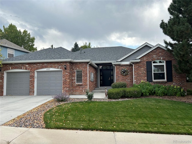 view of front of property featuring a garage and a front lawn