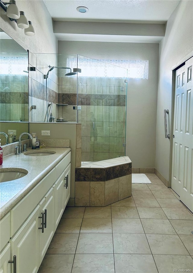 bathroom featuring vanity, tile patterned floors, and a shower with door