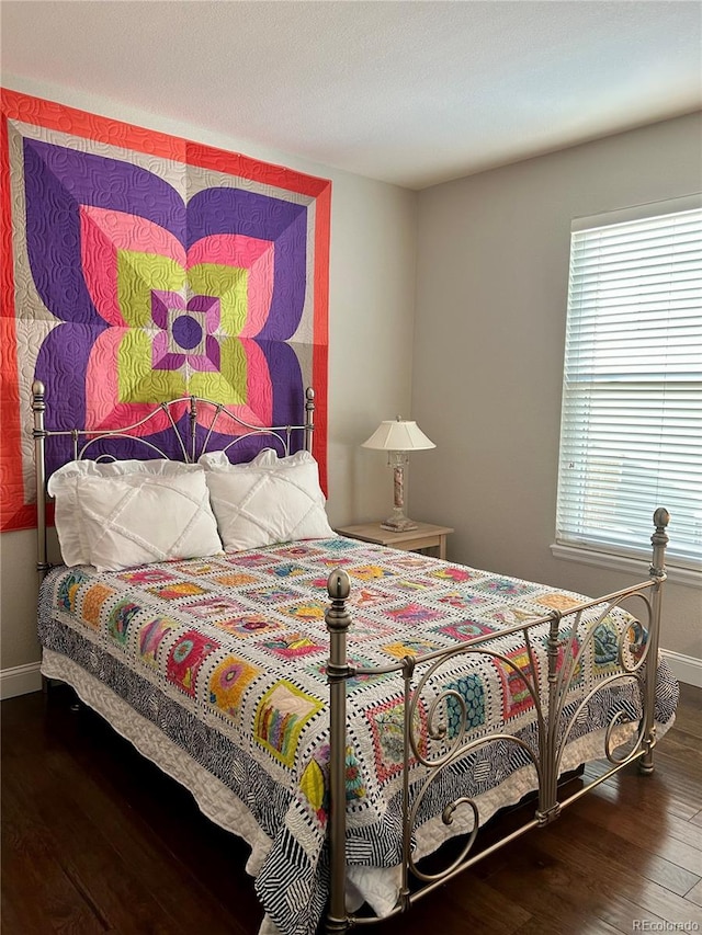 bedroom with hardwood / wood-style floors