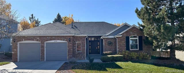 view of front facade featuring a garage and a front lawn