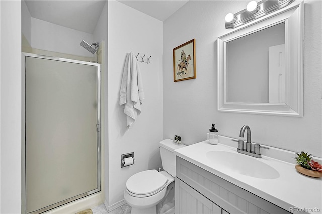 bathroom with toilet, a stall shower, and vanity