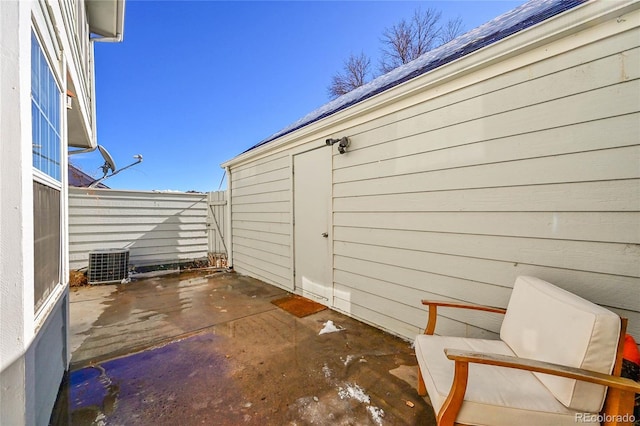 view of patio featuring cooling unit and fence