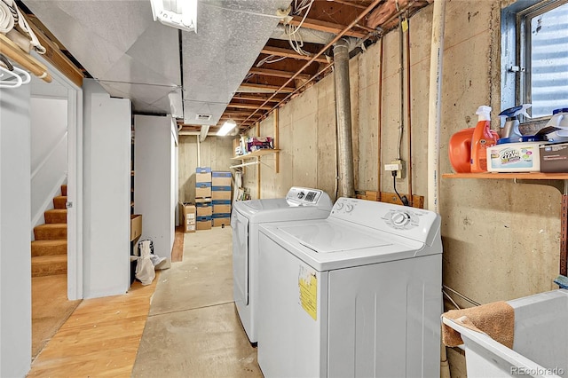 laundry area featuring laundry area, separate washer and dryer, and a sink