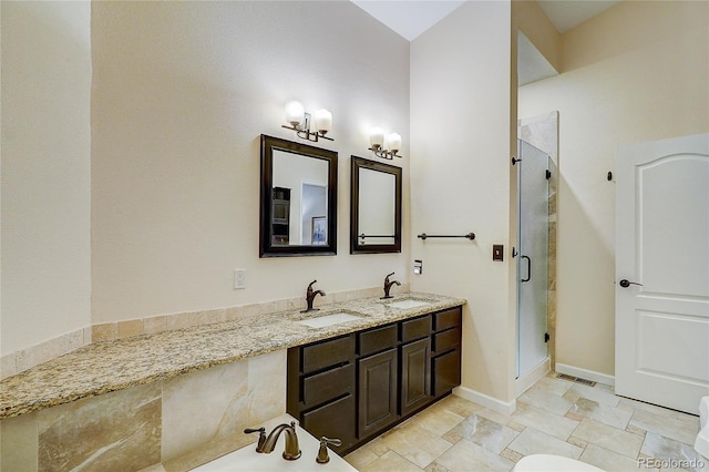 8754 Mesquite Row, Lone Tree, CO 80124 - bathroom featuring a shower stall, double vanity, stone finish floors, and a bathtub