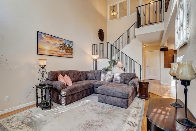 8754 Mesquite Row, Lone Tree, CO 80124 - living area featuring wood finished floors, stairs, and a high ceiling