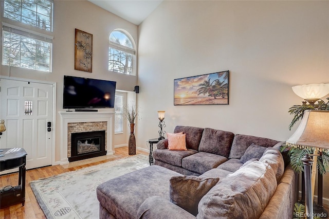 8754 Mesquite Row, Lone Tree, CO 80124 - living room with a high ceiling, light wood finished floors, and a fireplace with flush hearth