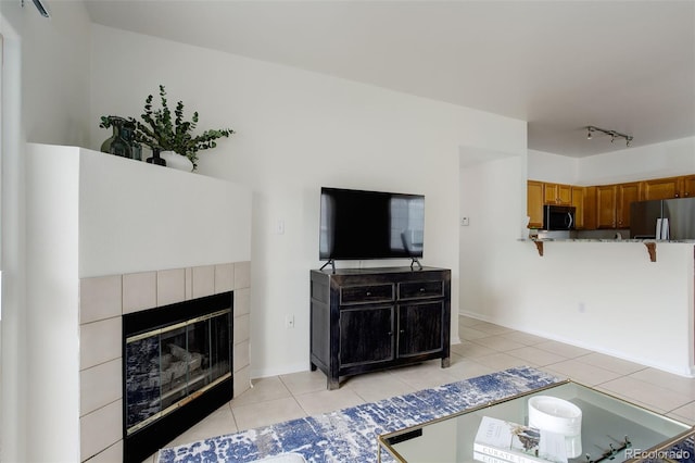 8415 Pebble Creek Way Unit 102, Highlands Ranch, CO 80126 - living area featuring light tile patterned floors and a tiled fireplace