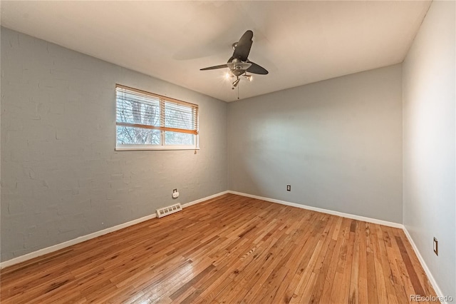 unfurnished room featuring visible vents, baseboards, light wood-type flooring, and a ceiling fan