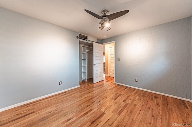 spare room featuring light wood-style floors, baseboards, and a ceiling fan