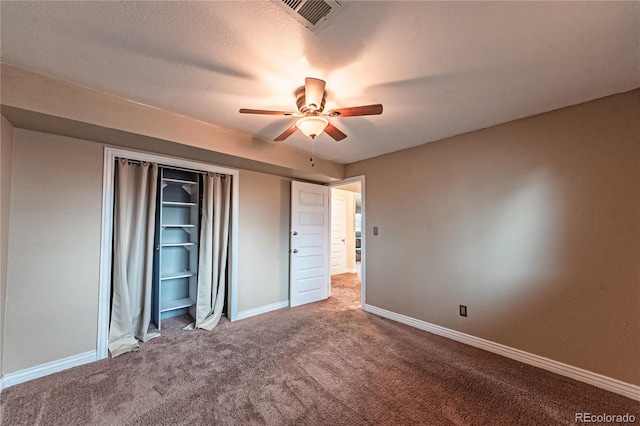 unfurnished bedroom with a closet, baseboards, carpet flooring, a ceiling fan, and visible vents