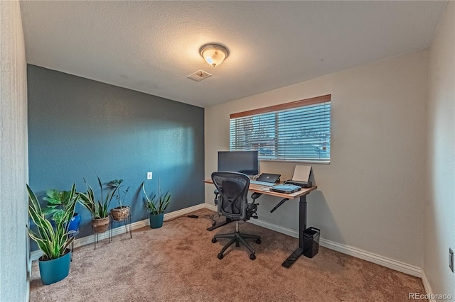 carpeted home office featuring visible vents, a textured ceiling, and baseboards