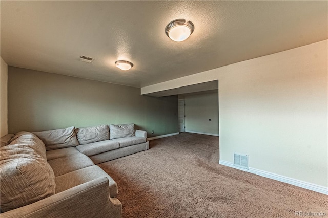 carpeted living area with visible vents, baseboards, and a textured ceiling