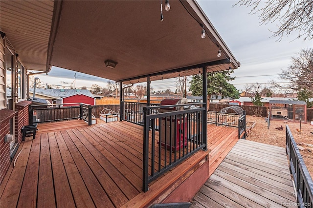 wooden deck with a fenced backyard