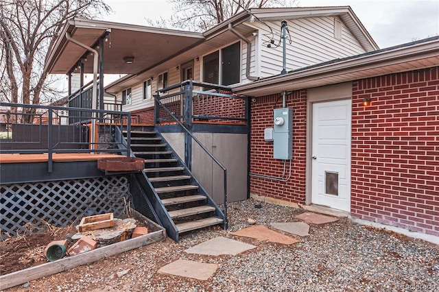 exterior space featuring brick siding and a deck