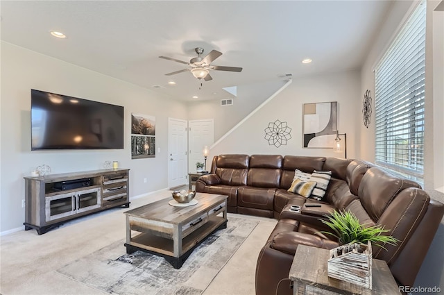 carpeted living room featuring ceiling fan