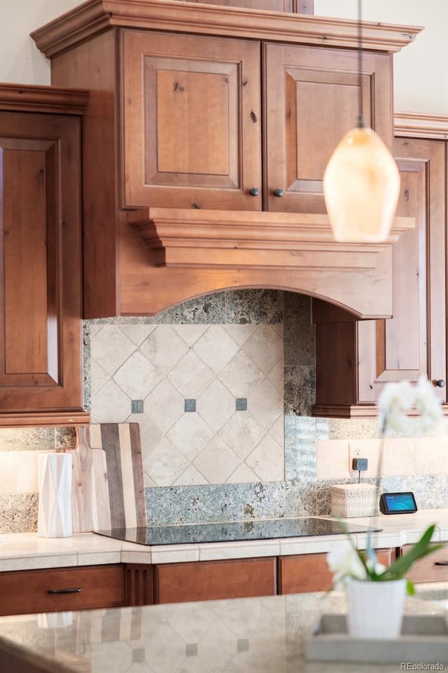 3143 Elmira St, Denver, CO 80238 - kitchen featuring tasteful backsplash, brown cabinets, and light countertops