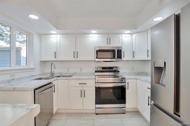 kitchen featuring sink, white cabinets, and stainless steel appliances