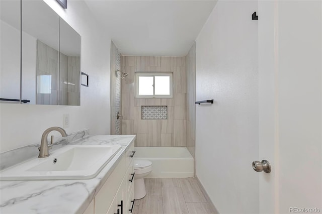 full bathroom featuring vanity, toilet, and tiled shower / bath