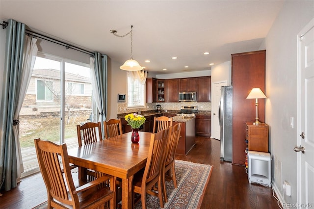 dining area featuring dark wood-type flooring and recessed lighting