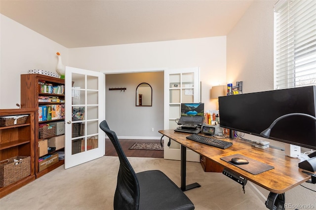 carpeted home office with french doors