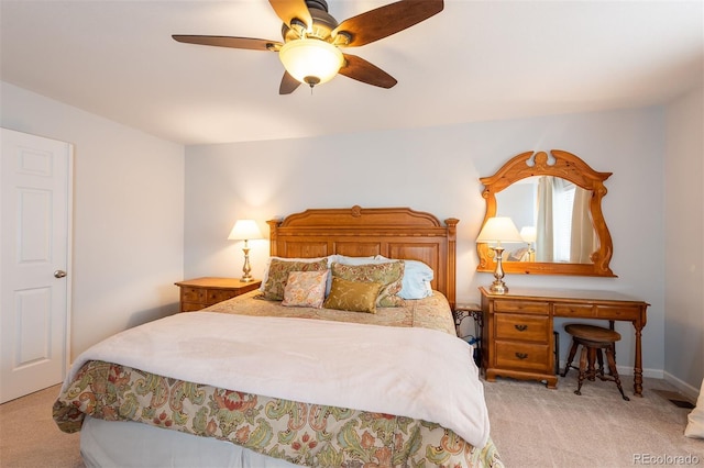 bedroom featuring a ceiling fan and light carpet