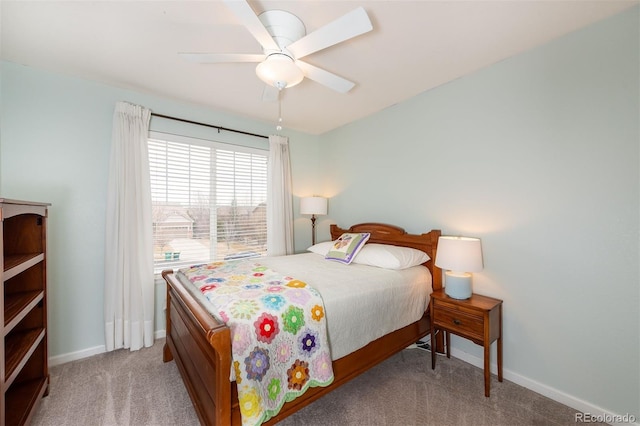 bedroom with light colored carpet, ceiling fan, and baseboards