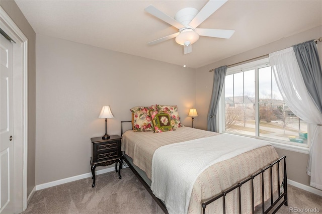 bedroom featuring baseboards, ceiling fan, and light colored carpet