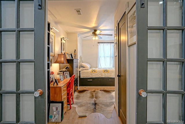 bathroom with ceiling fan and hardwood / wood-style flooring